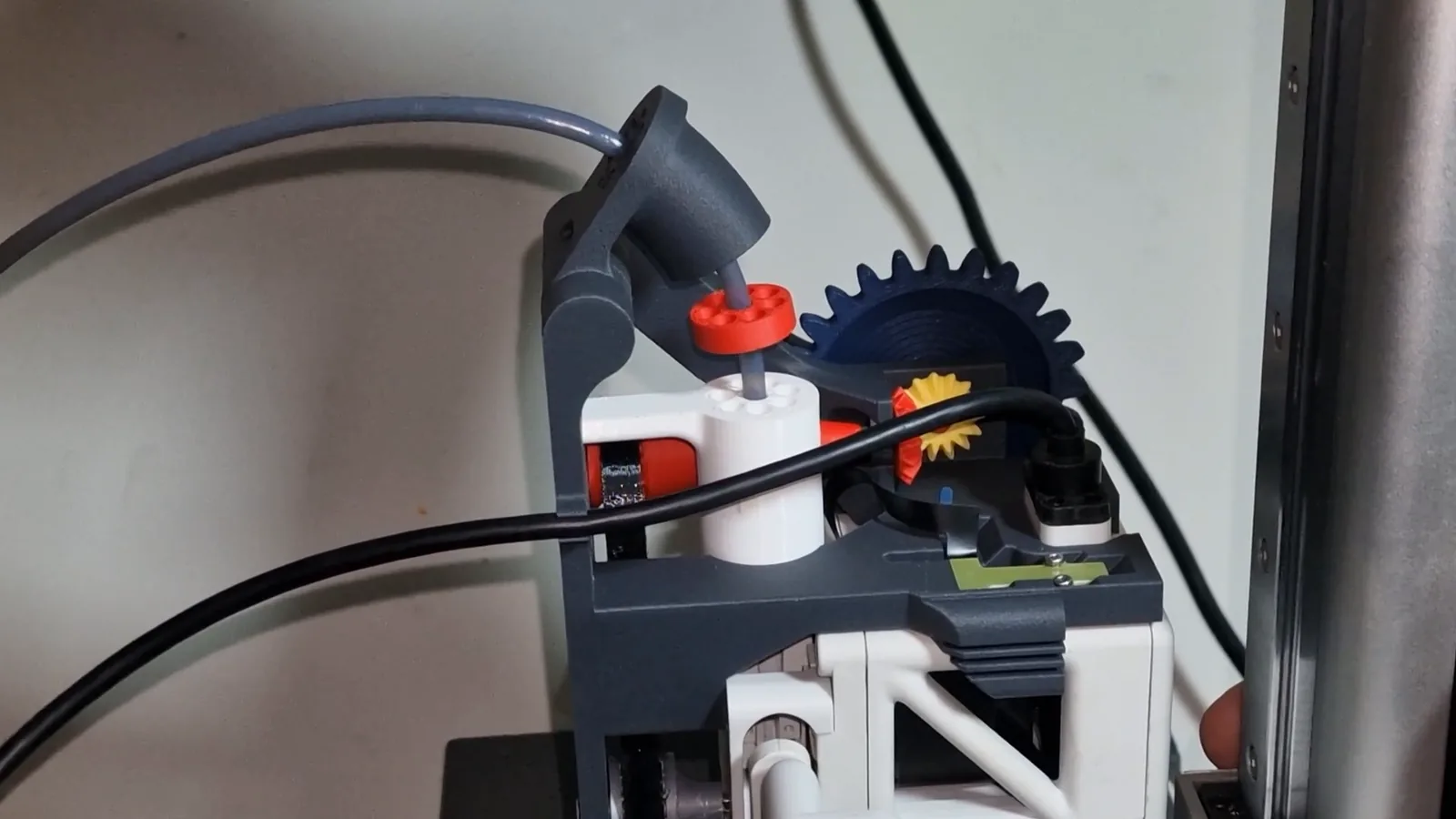 The Mechams toolhead module on a Bambu Lab A1 mini from the side, with a PTFE tube and the funnel in place