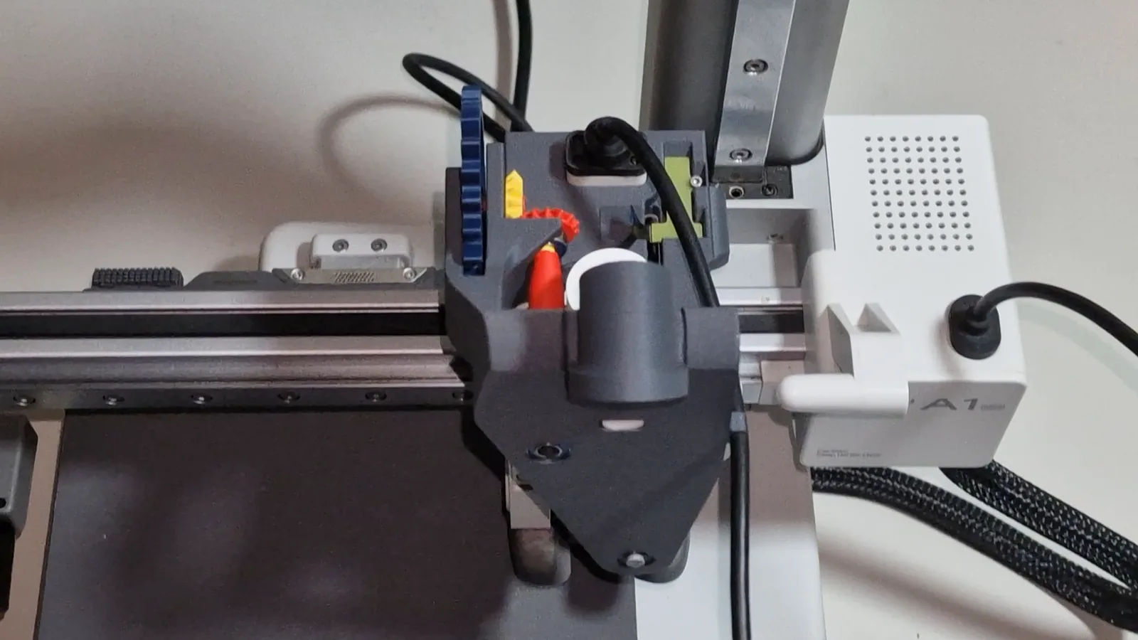 The Mechams module on a Bambu Lab A1 mini from the front, with the power cable seated in its holder