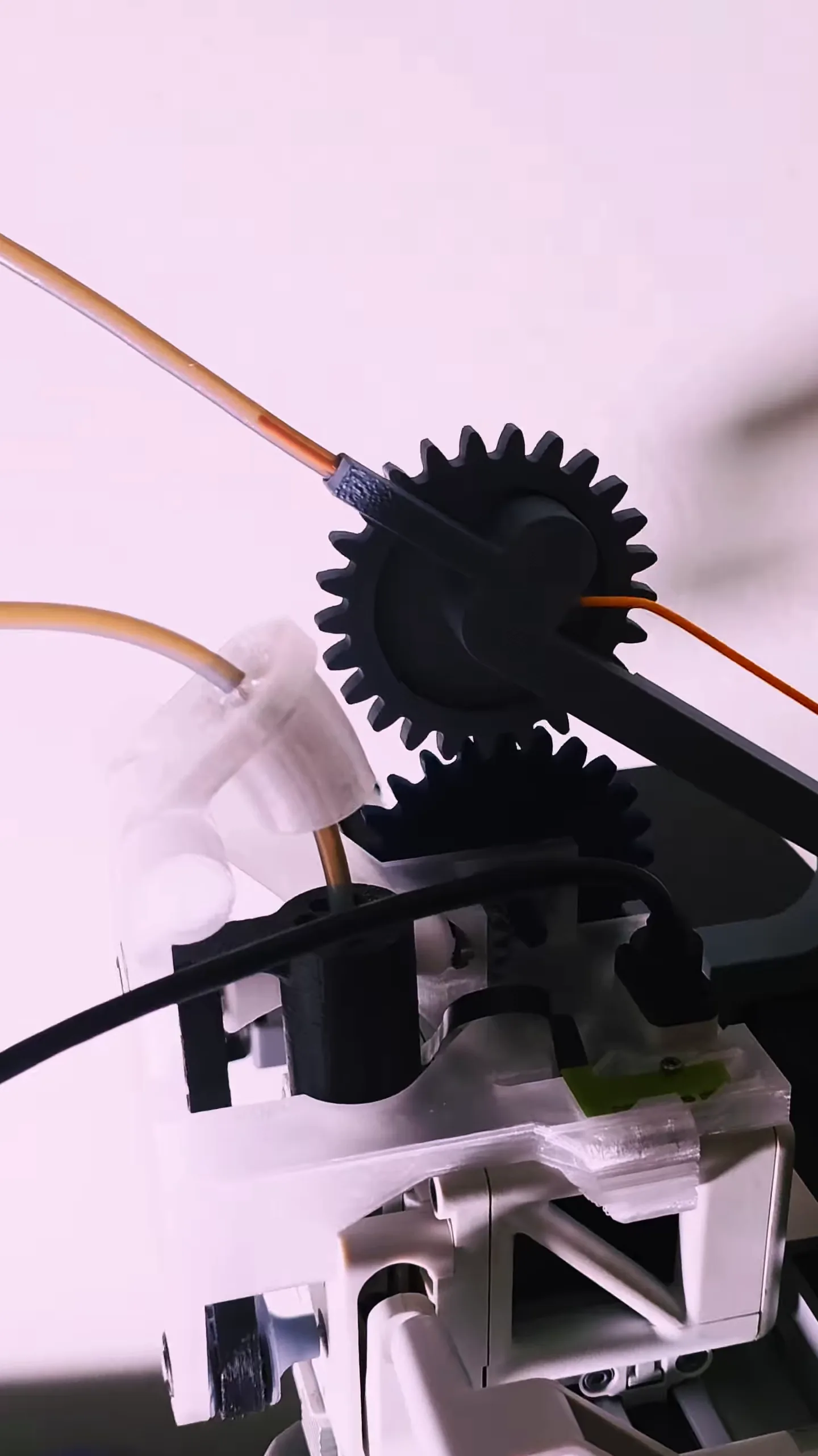 Side view of the mounted Mechams module, with filament loaded through the guide into the funnel