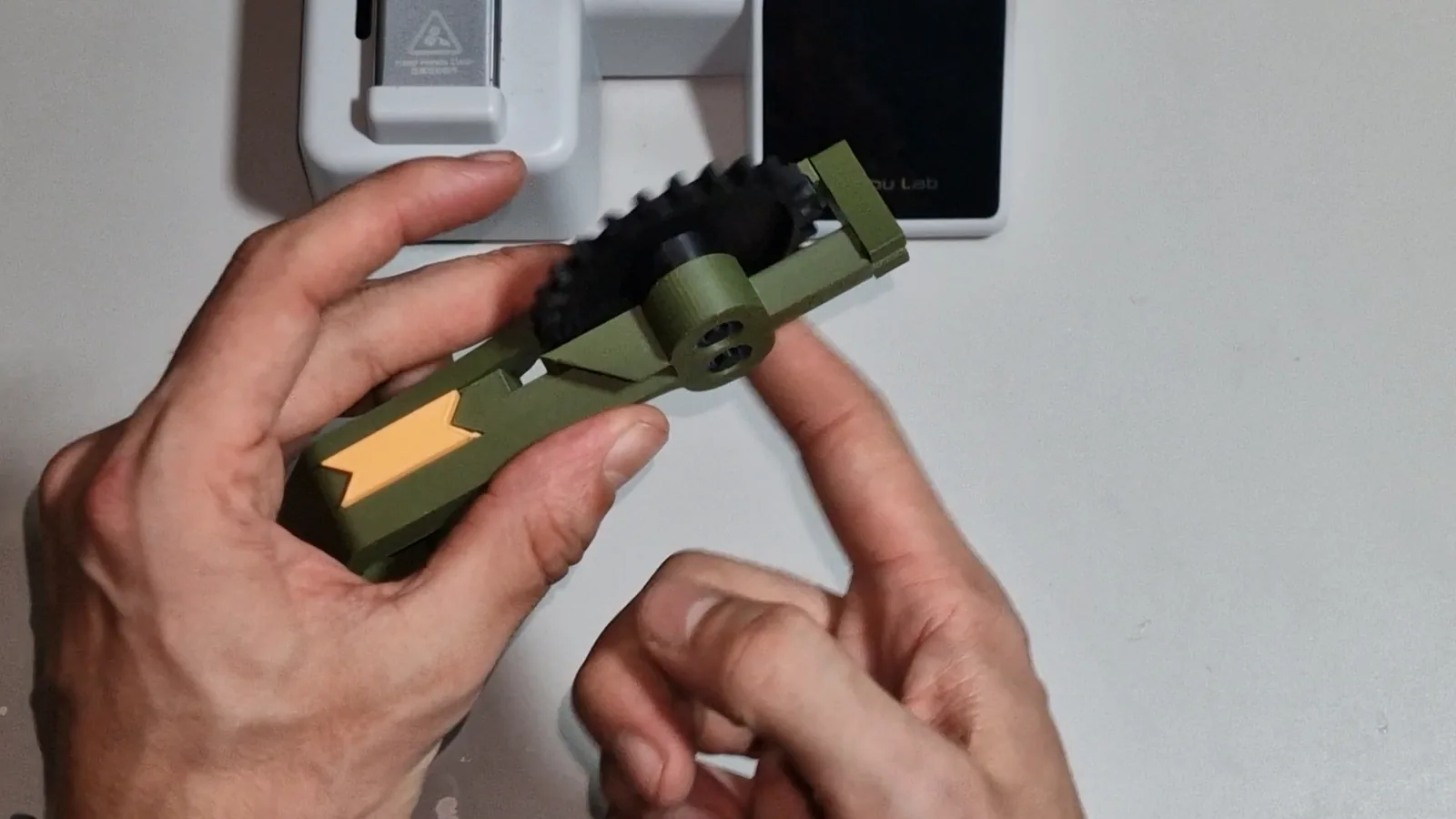 An assembled Mechams docking station seen from the side, with the yellow locking clip seated